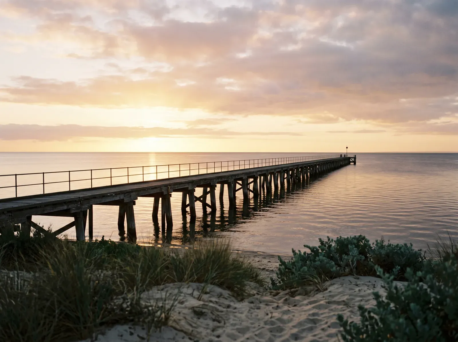 A western Adelaide beach jetty at sunset